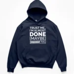 Typography reading TRUST ME I'M ALMOST DONE MAYBE with a 73 percent loading bar graphic on a Hoodie.