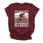 Distressed retro sunset graphic with a cyclist silhouette and text reading Never Underestimate An Engineer On A Bicycle on a Premium T-Shirt.
